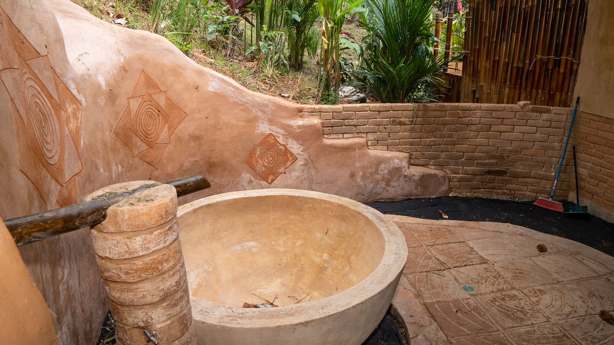 Bespoke hand-crafted outdoor bath and earthwork detail on a Costa Rica custom home build